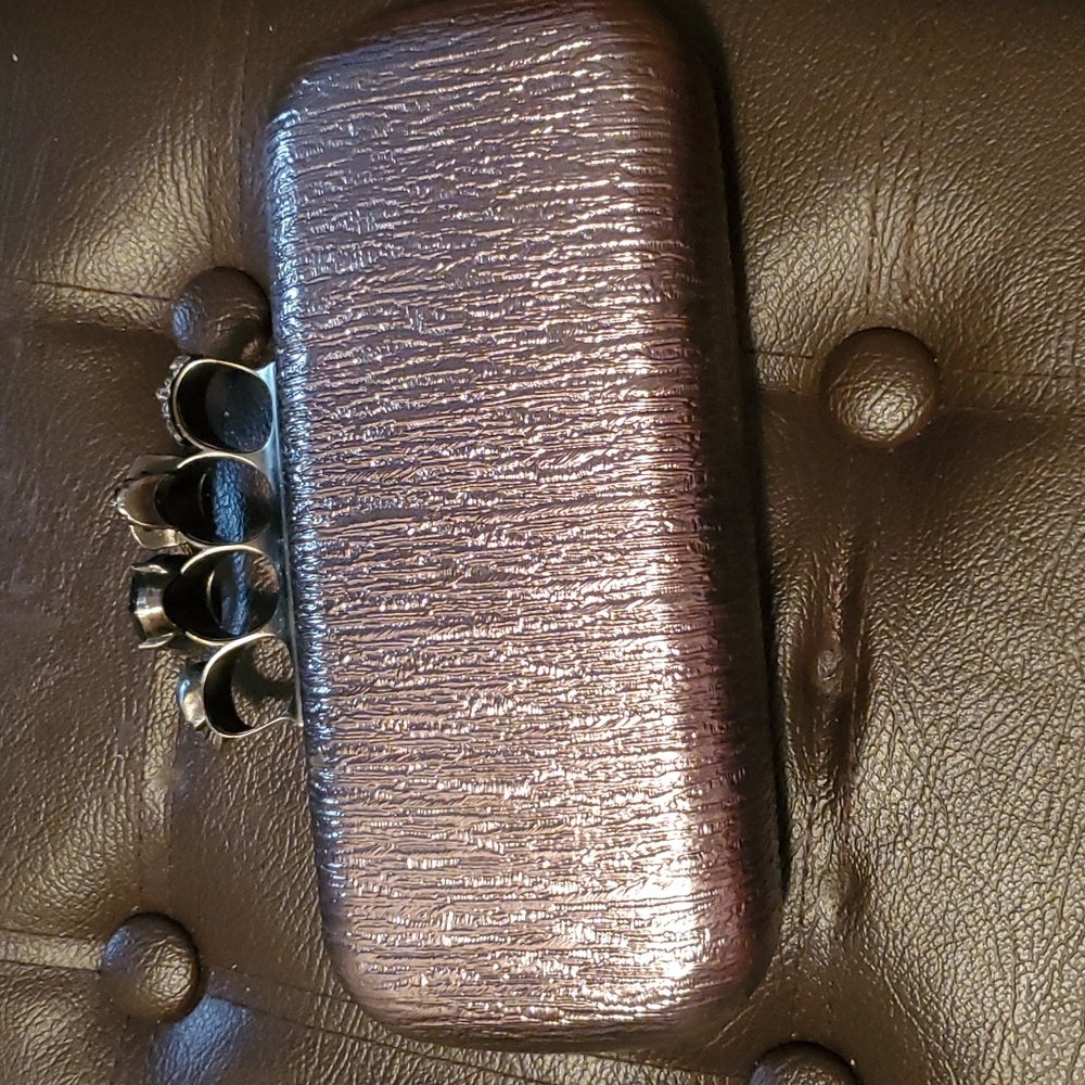 Silver skull detail clutch
